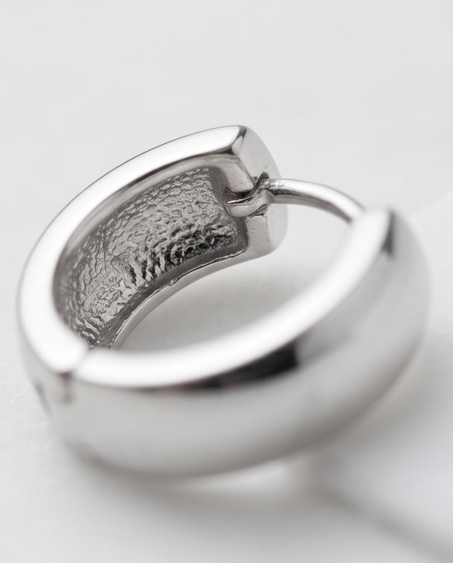 Minimalist silver‑tone hoop earrings with a smooth, polished finish