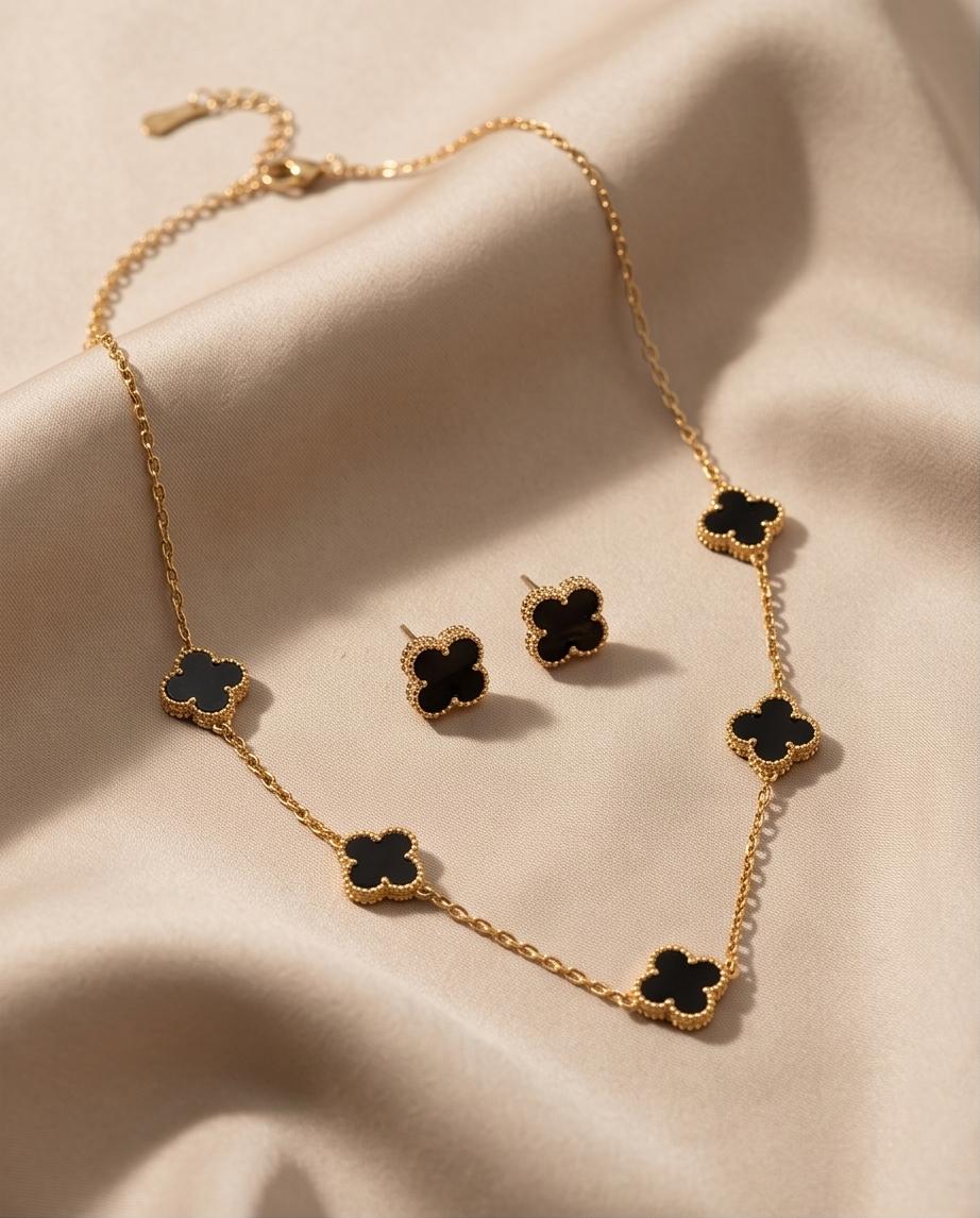A chic gold‑tone clover necklace and earring set