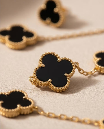 A chic gold‑tone clover necklace and earring set