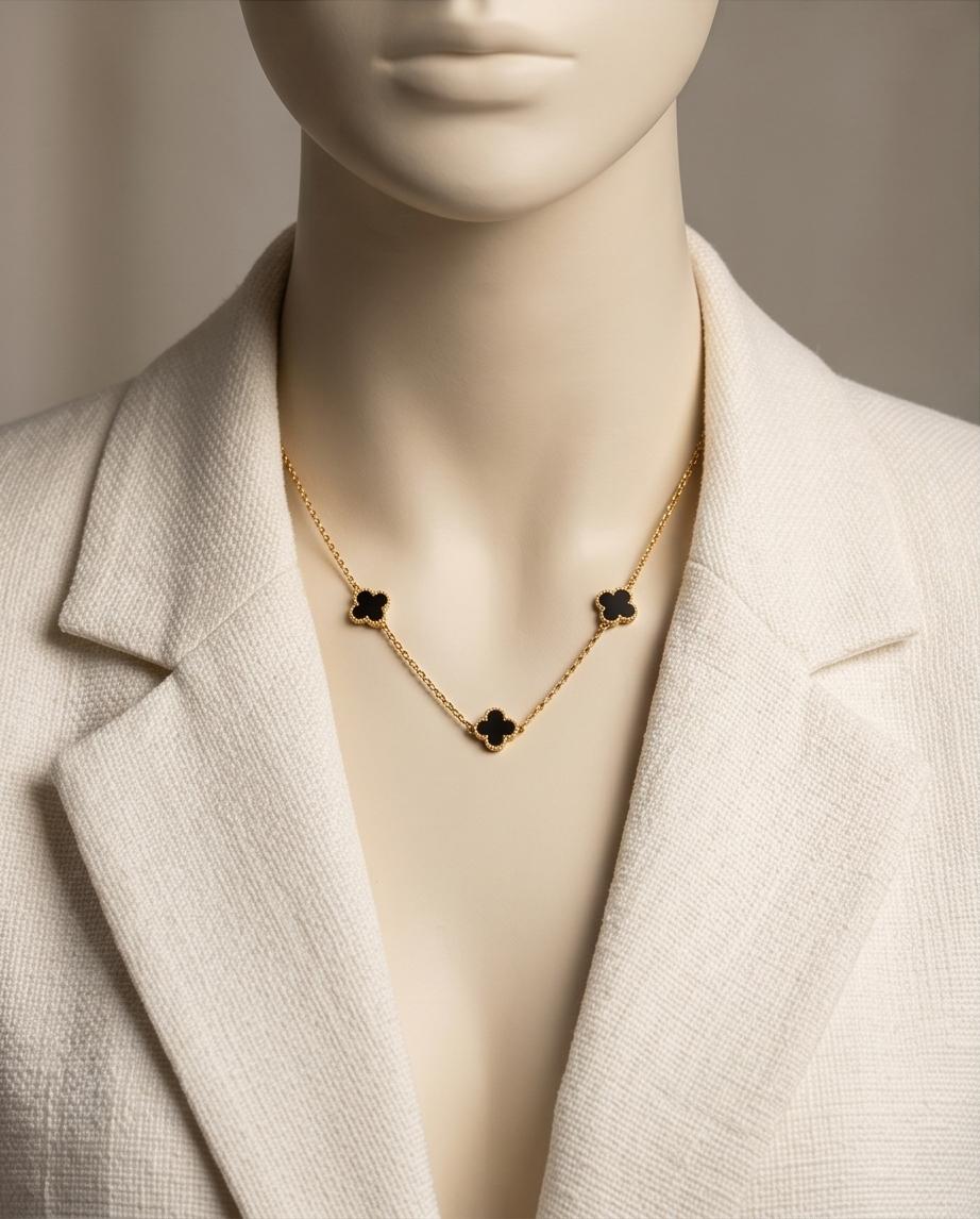 A chic gold‑tone clover necklace and earring set