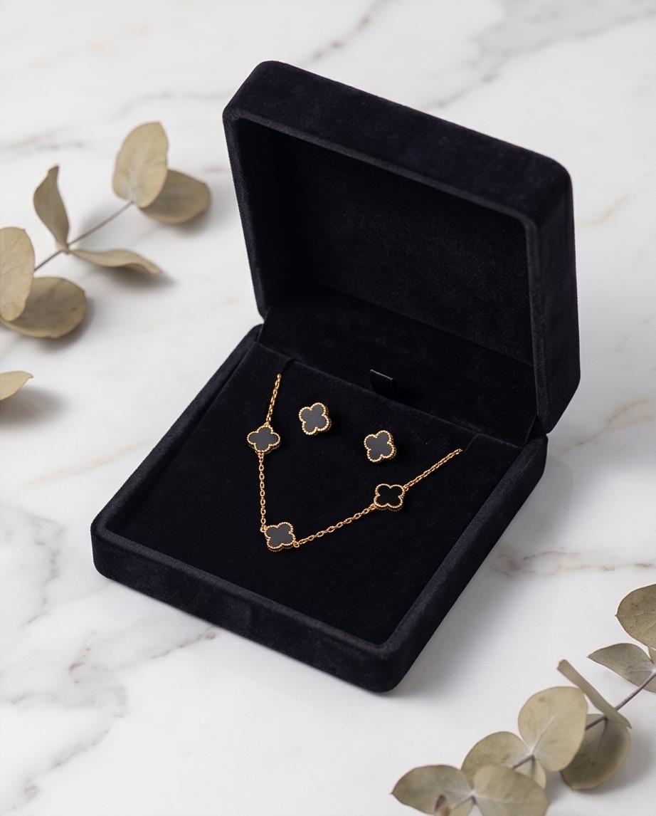 A chic gold‑tone clover necklace and earring set