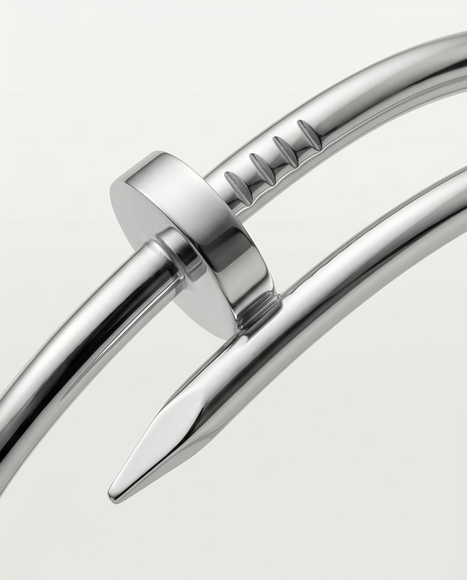A sleek silver‑tone nail‑inspired bangle